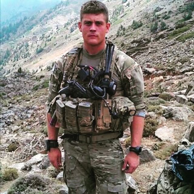 Cody Rose in combat gear on a mountainside during a deployment to Afghanistan.